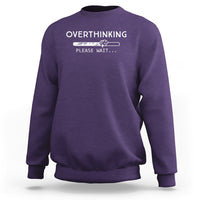 Purple sweatshirt with 'OVERTHINKING' 'PLEASE WAIT...' graphic on chest, crew neck