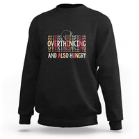 Black crewneck sweatshirt with cute cat and “Overthinking And Also Hungry” graphic