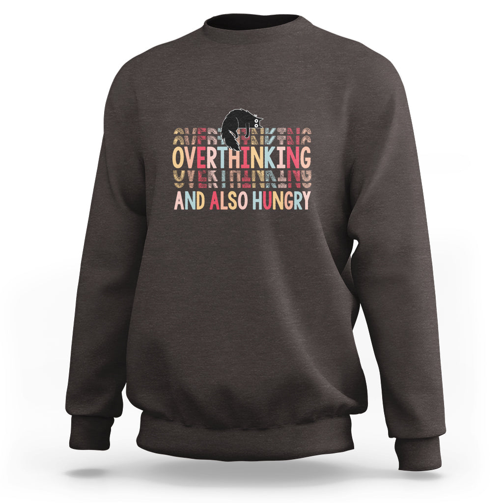 Dark brown crewneck sweatshirt with cute cat and “Overthinking And Also Hungry” graphic