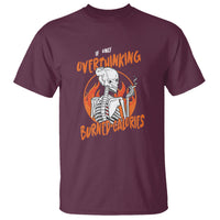 Maroon T-shirt with orange “Overthinking Burned Calories” skeleton graphic on front.