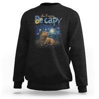 Black crewneck sweatshirt with colorful capybara night graphic on the front