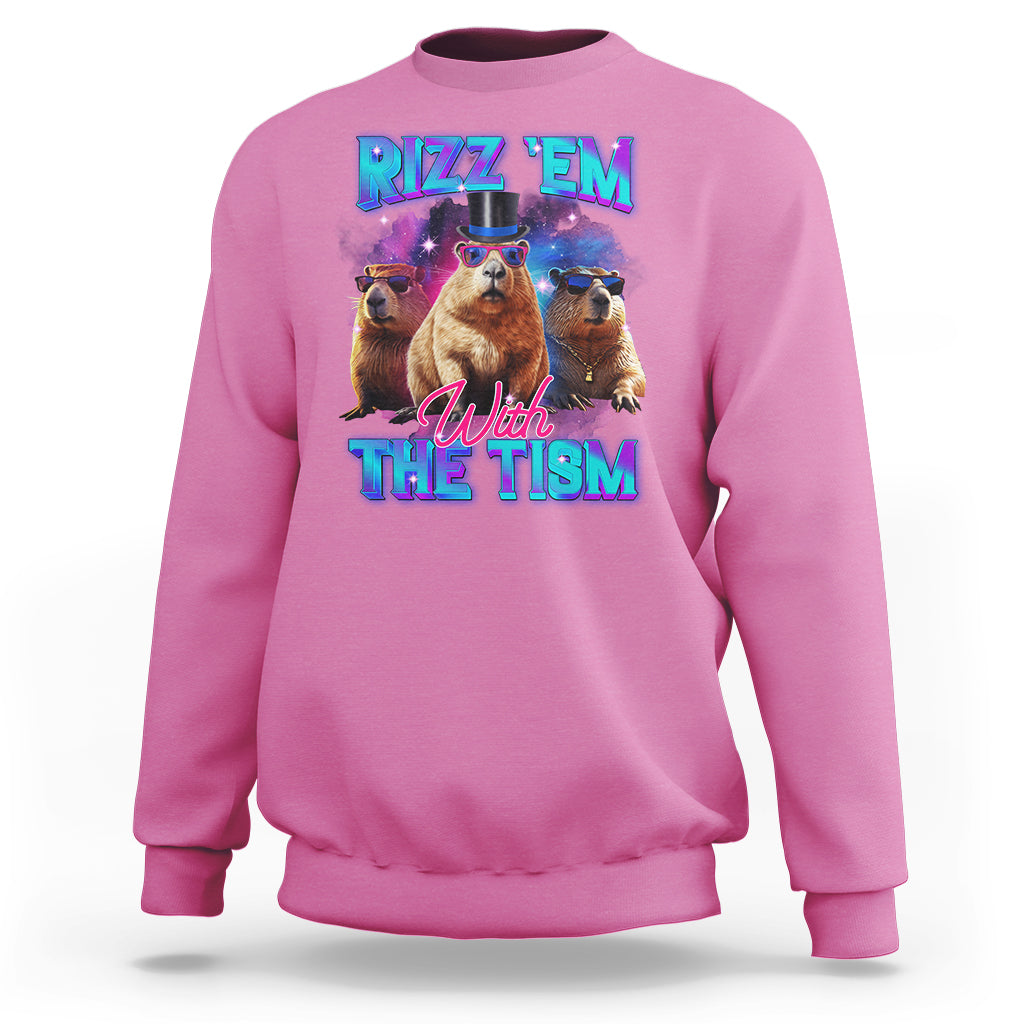 Azalea pink sweatshirt with capybara graphic: "RIZZ 'EM" "With THE TISM"