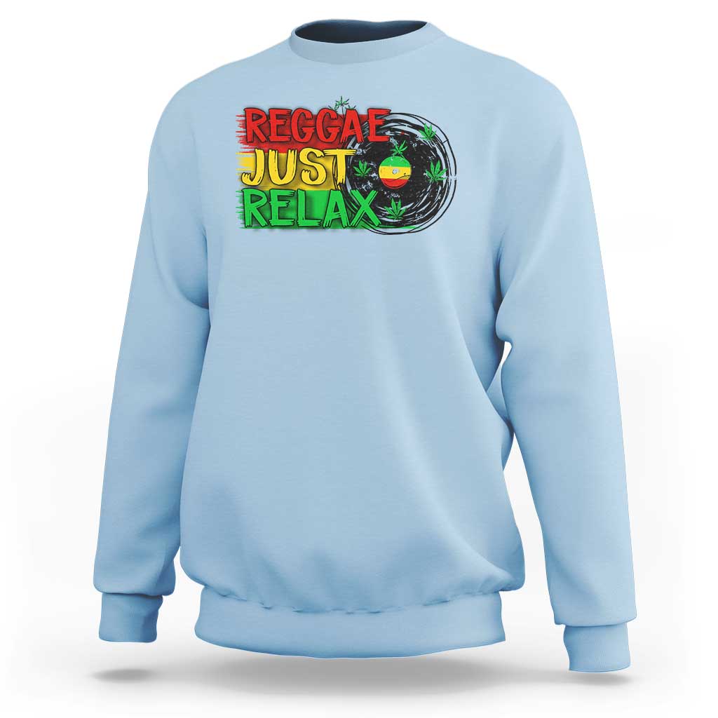 Light blue crewneck sweatshirt with colorful 'Reggae Just Relax' graphic and leaf print
