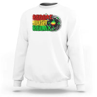 White crewneck sweatshirt with colorful 'Reggae Just Relax' graphic and leaf print