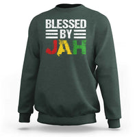 Dark forest green crewneck sweatshirt with 'Blessed By Jah' reggae-style JAH graphic on front.