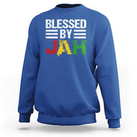 Royal blue crewneck sweatshirt with 'Blessed By Jah' reggae-style JAH graphic on front.