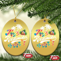 Pair of gold oval hanging ornaments with “Mele Kalikimaka” text