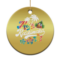 Gold round hanging Christmas ornament with “Mele Kalikimaka” print