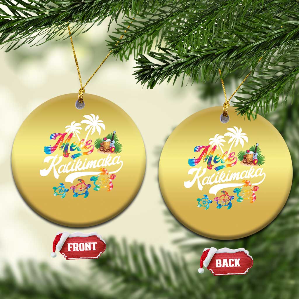 Pair of gold round hanging ornaments with “Mele Kalikimaka” text