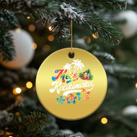 Gold round hanging ornament with “Mele Kalikimaka” design and palms