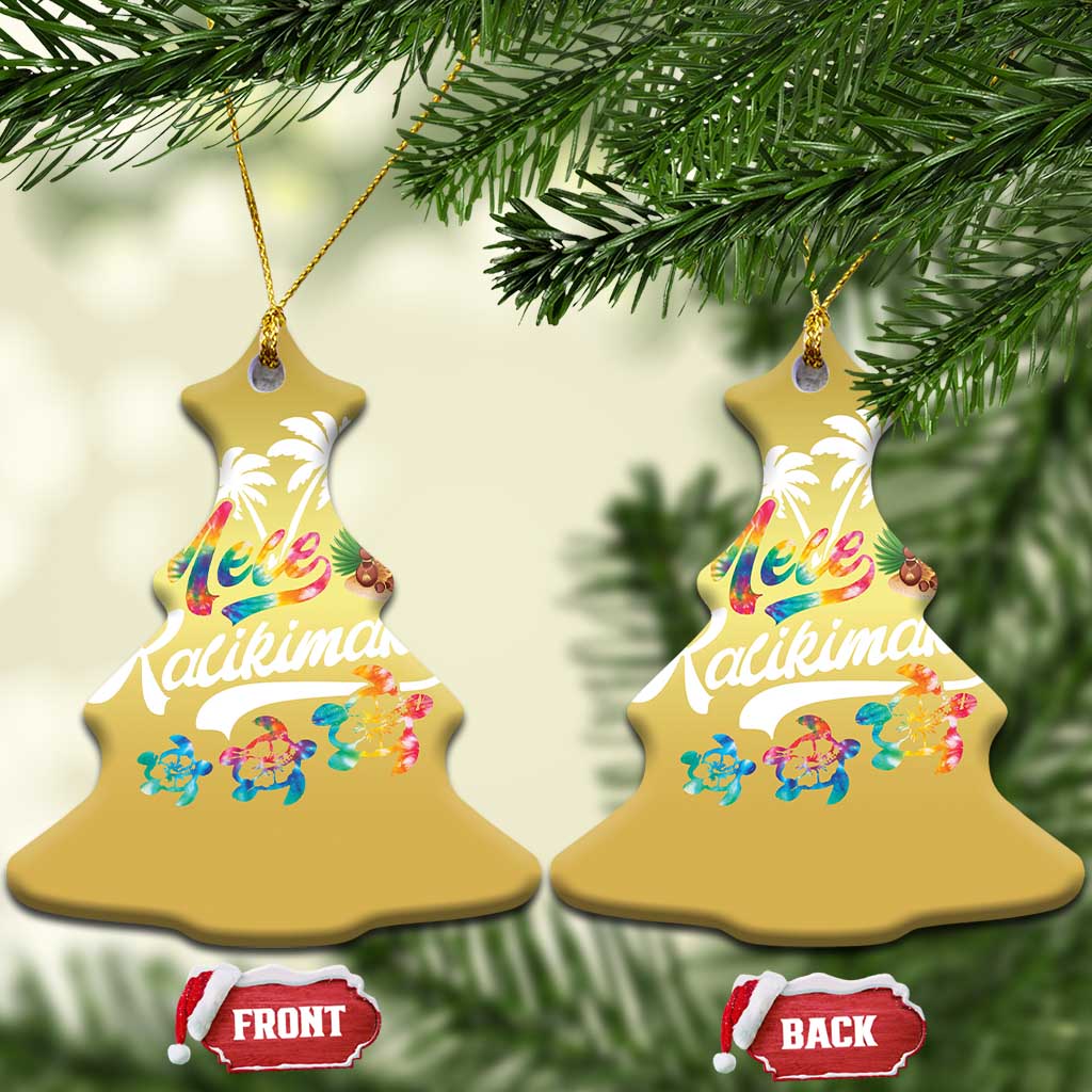 Two gold bell-shaped hanging ornaments with “Mele Kalikimaka” design