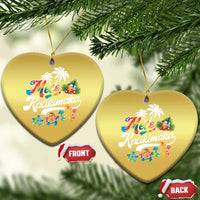 Pair of gold heart hanging ornaments with “Mele Kalikimaka” print