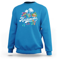 Bright blue Christmas sweatshirt with Mele Kalikimaka graphic of turtles and palms