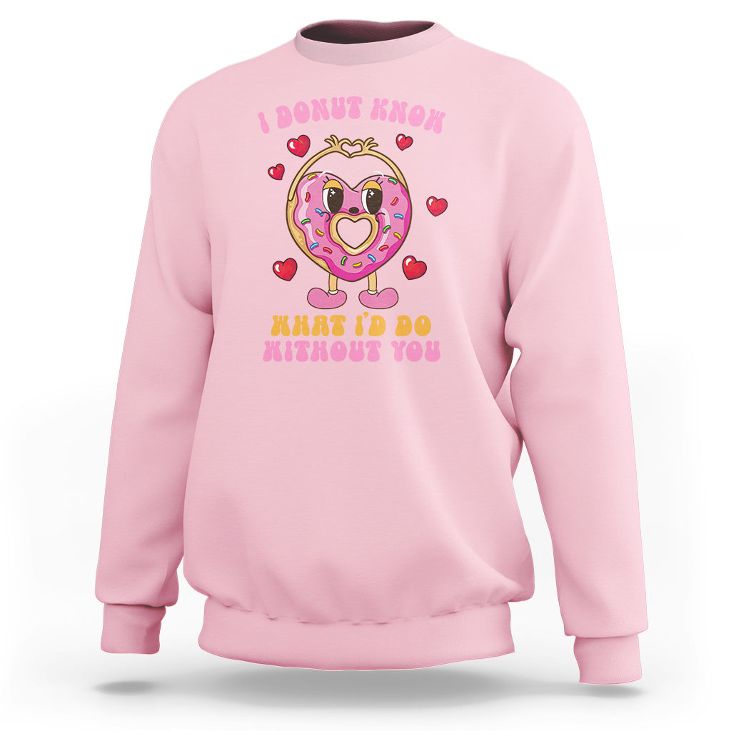 Light pink Valentine’s Day sweatshirt with donut character graphic and red heart icons