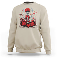Sand beige sweatshirt with skeleton drummer graphic and red drum set artwork on front