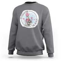 Charcoal gray crewneck sweatshirt with circular skeleton and rose floral graphic on chest.
