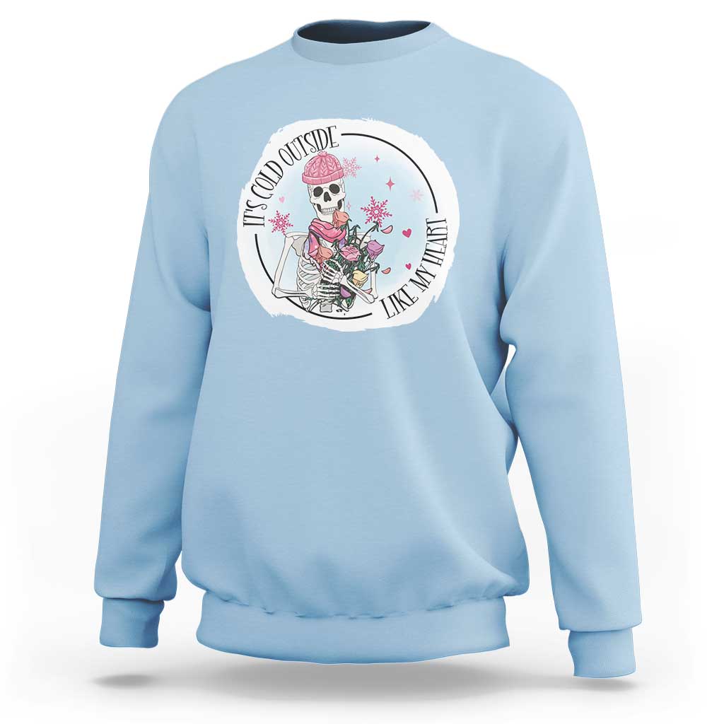 Light blue crewneck sweatshirt with circular skeleton and rose floral graphic on chest.