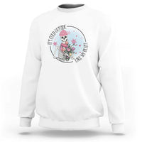 White crewneck sweatshirt with circular skeleton and rose floral graphic on chest.