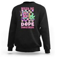 Black crewneck sweatshirt with colorful front graphic reading “Weed Be Dope Together”.