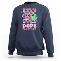 Navy crewneck sweatshirt with colorful front graphic reading “Weed Be Dope Together”.