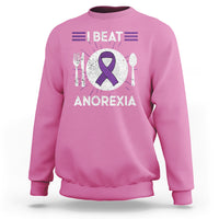 Azalea pink sweatshirt with purple ribbon “I BEAT ANOREXIA” graphic and fork/spoon symbols