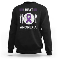 Black sweatshirt with purple ribbon “I BEAT ANOREXIA” graphic and fork/spoon symbols