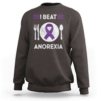 Dark chocolate sweatshirt with purple ribbon “I BEAT ANOREXIA” graphic and fork/spoon symbols