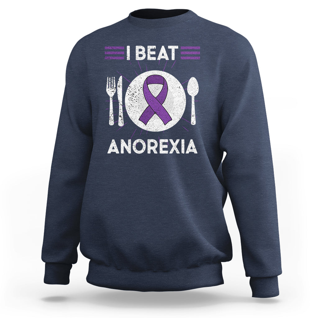 Navy sweatshirt with purple ribbon “I BEAT ANOREXIA” graphic and fork/spoon symbols