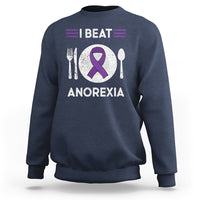 Navy sweatshirt with purple ribbon “I BEAT ANOREXIA” graphic and fork/spoon symbols