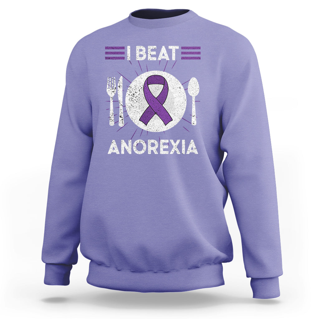 Violet sweatshirt with purple ribbon “I BEAT ANOREXIA” graphic and fork/spoon symbols