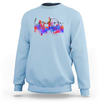 Light blue crewneck sweatshirt with multicolor city skyline graphic on front