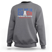 Charcoal gray crewneck sweatshirt with blue “Put Me In Coach” election graphic on front