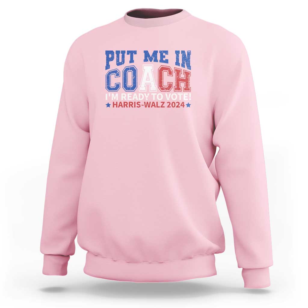 Light pink crewneck sweatshirt with blue “Put Me In Coach” election graphic on front