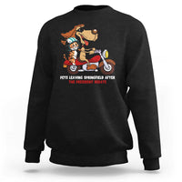 Black sweatshirt with cartoon pets graphic and red slogan text on the chest