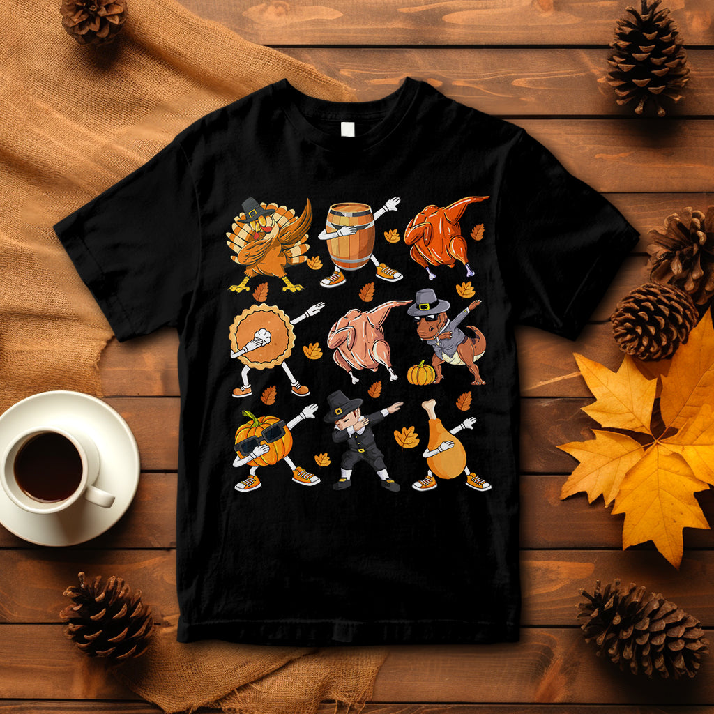 Black Thanksgiving graphic T-shirt with dancing turkey, dinosaur, and pumpkin pie characters