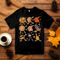 Black Thanksgiving graphic T-shirt with dancing turkey, dinosaur, and pumpkin pie characters