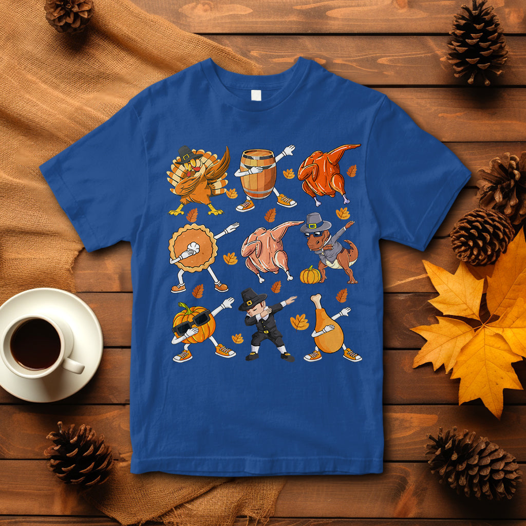 Blue Thanksgiving graphic T-shirt with dancing turkey, dinosaur, and pumpkin pie characters