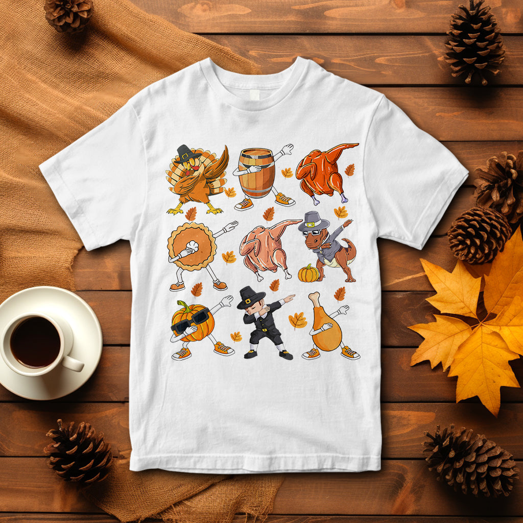 White Thanksgiving graphic T-shirt with dancing turkey, dinosaur, and pumpkin pie characters
