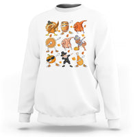 White crewneck sweatshirt with colorful Thanksgiving character graphic on the chest