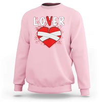 Light pink crewneck sweatshirt with 'LOVER' heart graphic, long sleeves.