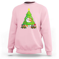 Light pink Christmas cat sweatshirt with colorful cat under green tree graphic