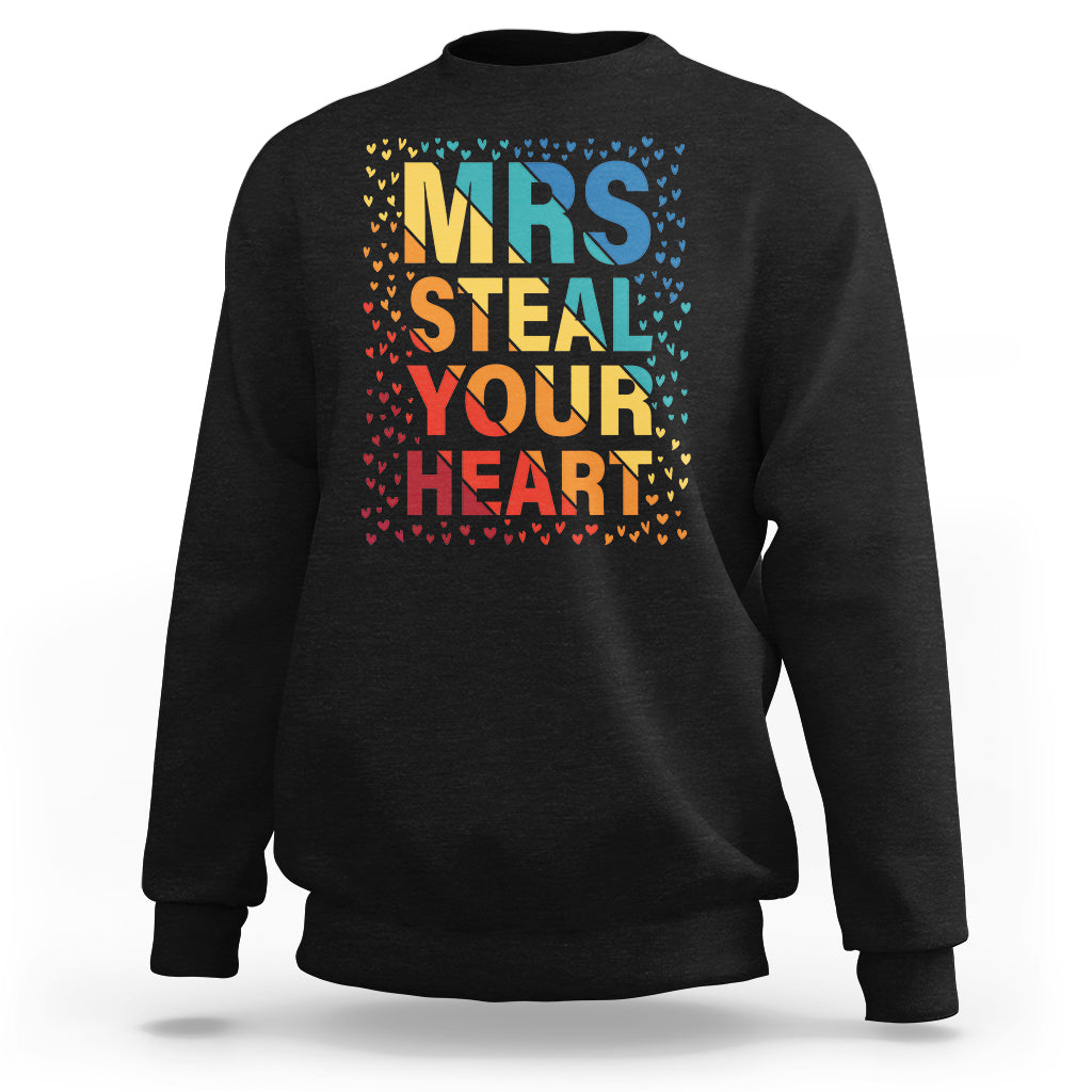 Women’s black graphic sweatshirt with “MRS STEAL YOUR HEART” rainbow heart print