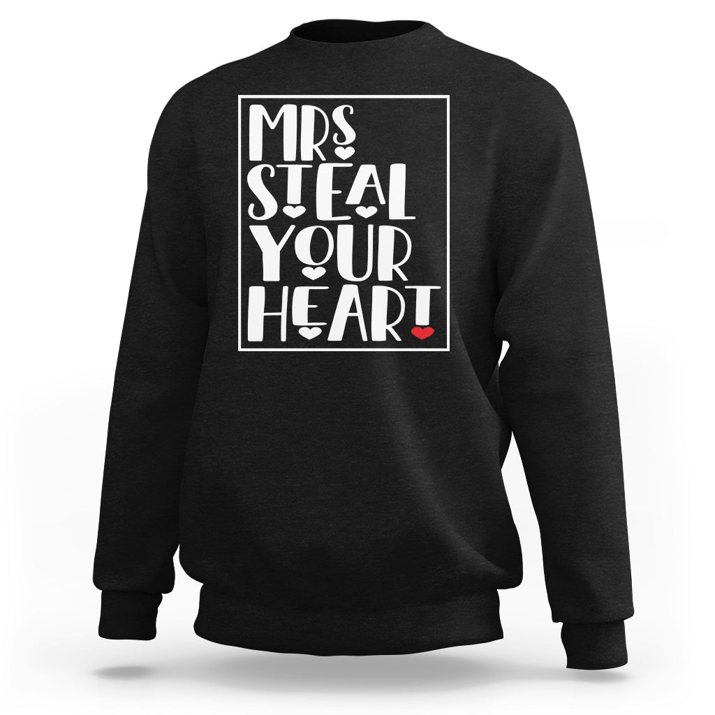 Women's crewneck sweatshirt, black, with white graphic text 'Mrs Steal Your Heart' and red heart.