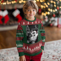 Kids' ugly Christmas sweater in green and cream knit with cat-and-Santa front graphic