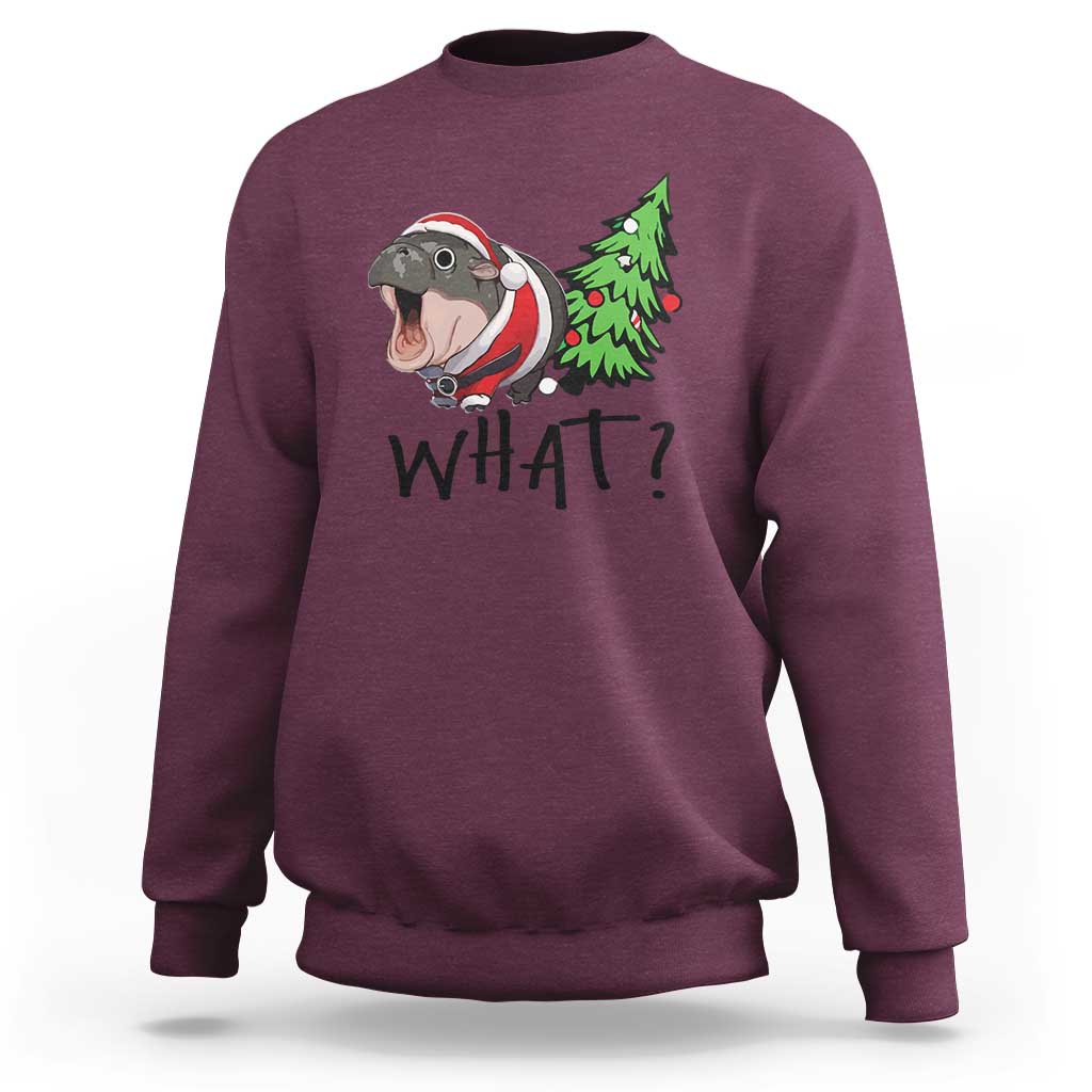 Maroon sweatshirt with cartoon hippo pushing green Christmas tree, “WHAT?” front print