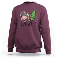 Maroon sweatshirt with cartoon hippo pushing green Christmas tree, “WHAT?” front print