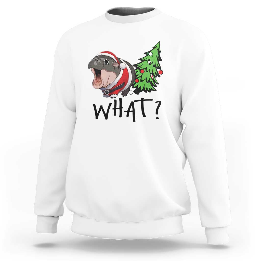 White sweatshirt with cartoon hippo pushing green Christmas tree, “WHAT?” front print