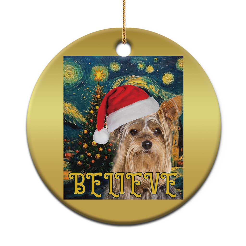 Gold round Christmas ornament with Yorkshire dog in Santa hat and “BELIEVE” text