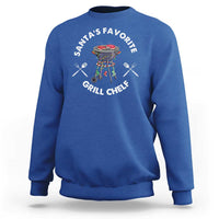 Royal blue crewneck sweatshirt with BBQ chef graphic and “Santa’s Favorite Grill Chef” text.
