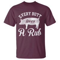 Graphic T-shirt in maroon with 'Every Butt loves A Rub' pig front print.